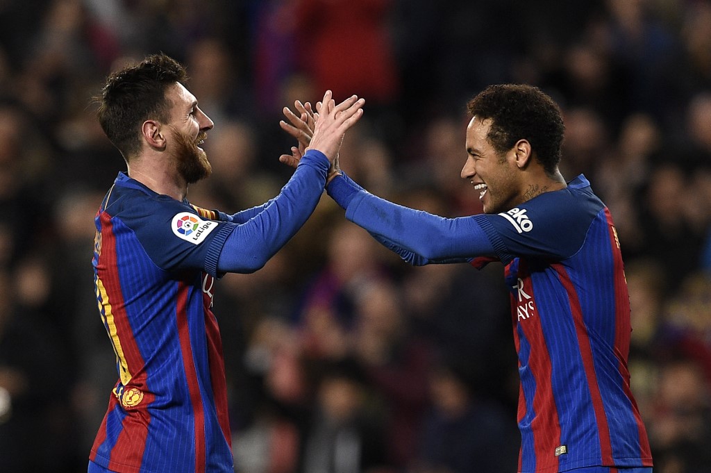 Barcelona's Argentinian forward Lionel Messi (L) celebrates with Barcelona's Brazilian forward Neymar (R) after scoring a goal during the Spanish league football match FC Barcelona vs RC Celta de Vigo at the Camp Nou stadium in Barcelona on March 4, 2017. 