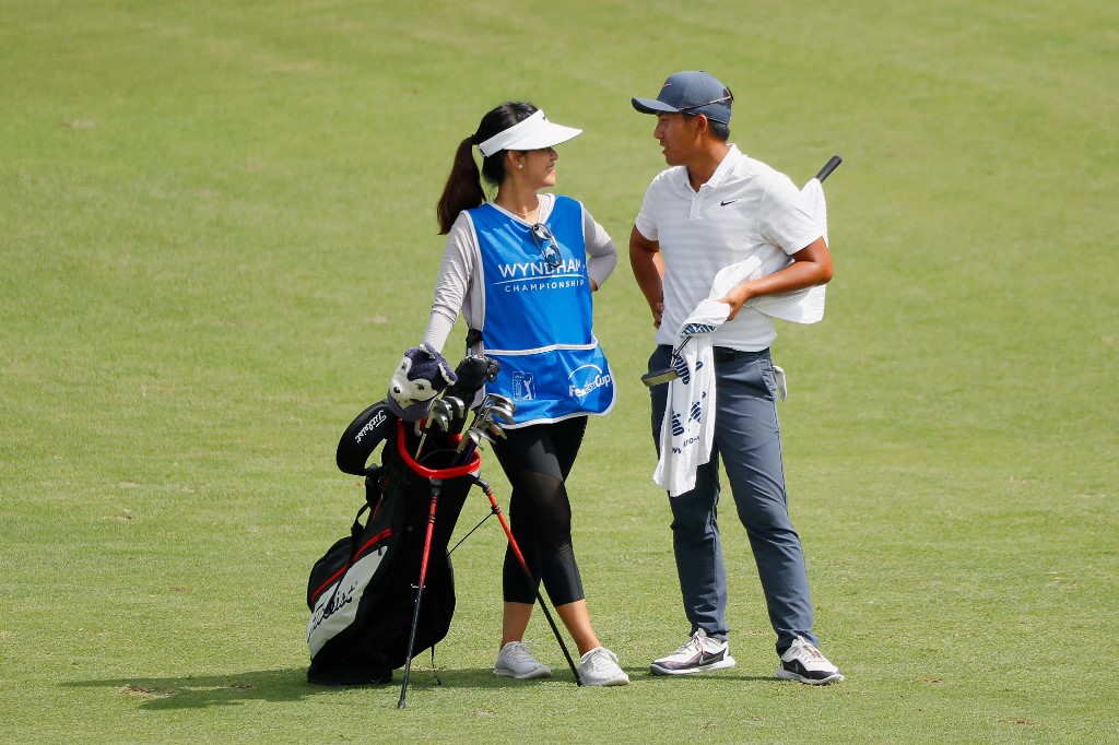  C.T. Pan of Taiwan stands in the ninth fairway with his wife and caddie Michelle Lin during the final round of the Wyndham Championship at Sedgefield Country Club on August 19, 2018 in Greensboro, North Carolina. 
