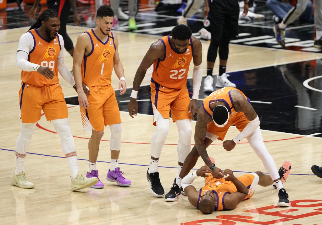 LOS ANGELES, CALIFORNIA - JUNE 30: Chris Paul #3 of the Phoenix Suns celebrates a three point basket and drawing the foul with teammates Torrey Craig #12, Deandre Ayton #22, Devin Booker #1 and Jae Crowder #99 during the second half in Game Six of the Western Conference Finals against the LA Clippers at Staples Center on June 30, 2021 in Los Angeles, California.