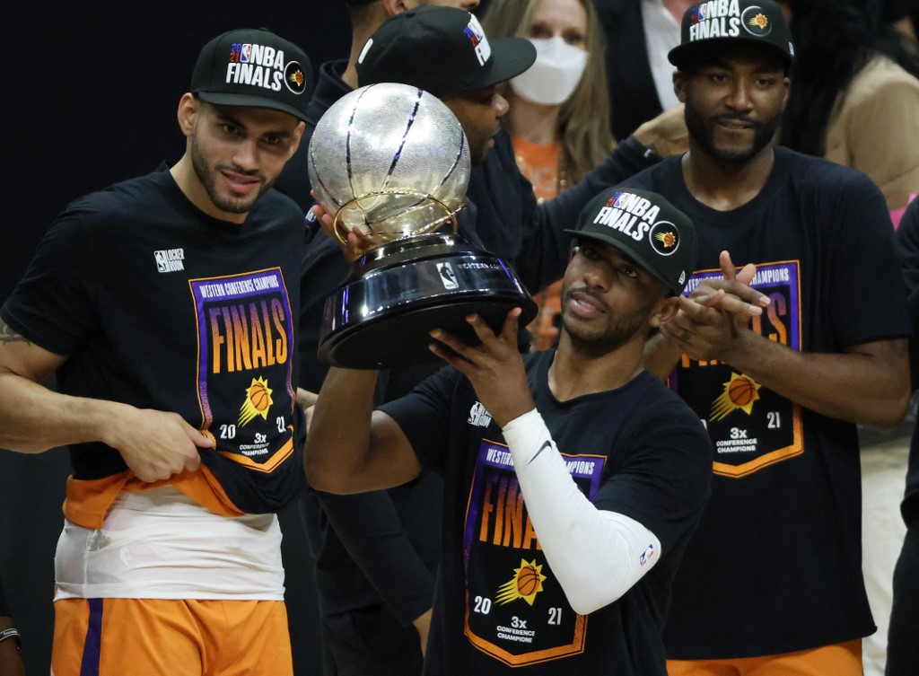 Chris Paul #3 of the Phoenix Suns holds the Western Conference Championship trophy after the Suns defeated the LA Clippers in Game Six of the Western Conference Finals at Staples Center