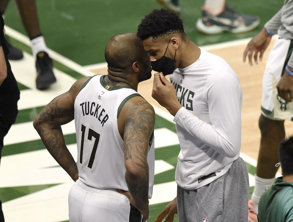Giannis Antetokounmpo #34 of the Milwaukee Bucks talks with P.J. Tucker #17 during a time out during the first half in Game Five of the Eastern Conference Finals against the Atlanta Hawksat Fiserv Forum