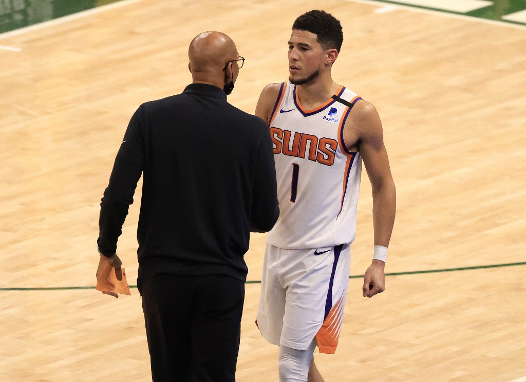  Head coach Monty Williams of the Phoenix Suns talks with Devin Booker #1 during the second half in Game Three of the NBA Finals against the Milwaukee Bucks at Fiserv Forum on July 11, 2021 in Milwaukee, Wisconsin