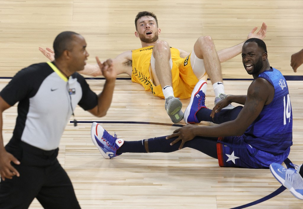 Nick Kay #15 of the Australia Boomers and Draymond Green #14 of the United States react after Kay fouled Green during an exhibition game at Michelob Ultra Arena ahead of the Tokyo Olympic Games on July 12, 2021 in Las Vegas, Nevada