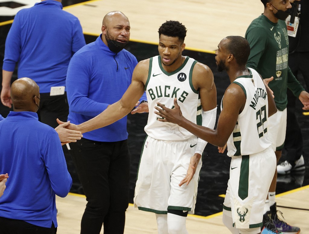  Giannis Antetokounmpo #34 of the Milwaukee Bucks is congratulated by Khris Middleton #22 while coming to the bench for a time out against the Phoenix Suns during the second half in Game Five of the NBA Finals at Footprint Center on July 17, 2021 in Phoenix, Arizona.