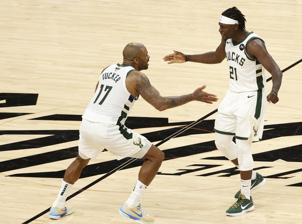  P.J. Tucker #17 and Jrue Holiday #21 of the Milwaukee Bucks celebrate a team win against the Phoenix Suns in Game Five of the NBA Finals at Footprint Center on July 17, 2021 in Phoenix, Arizona