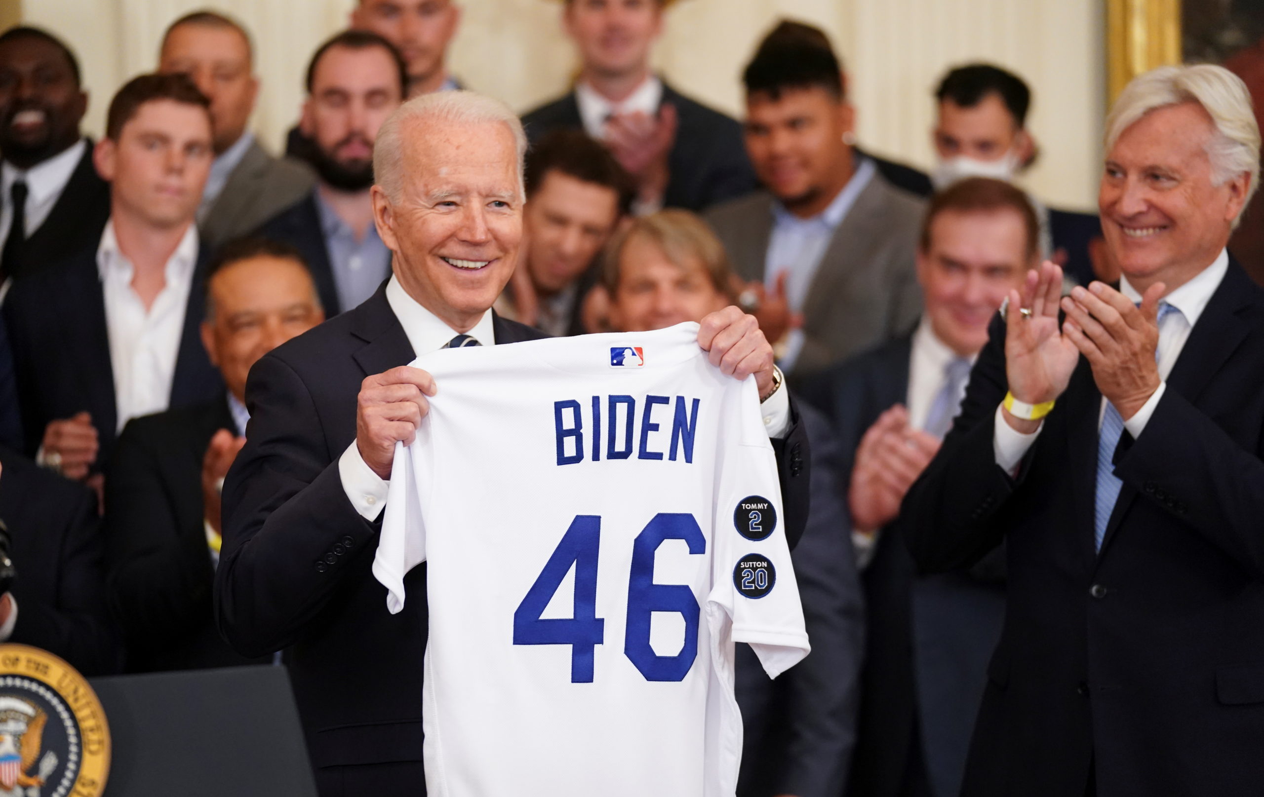 U.S. President Joe Biden holds up team a jersey given to him during a ceremony honoring the members of the 2020 World Series Champion Los Angeles Dodgers in the East Room at the White House i