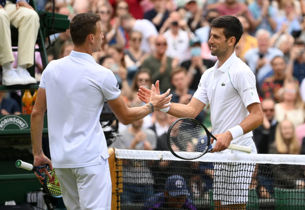 Serbia's Novak Djokovic shakes hands with Hungary's Marton Fucsovics after the match