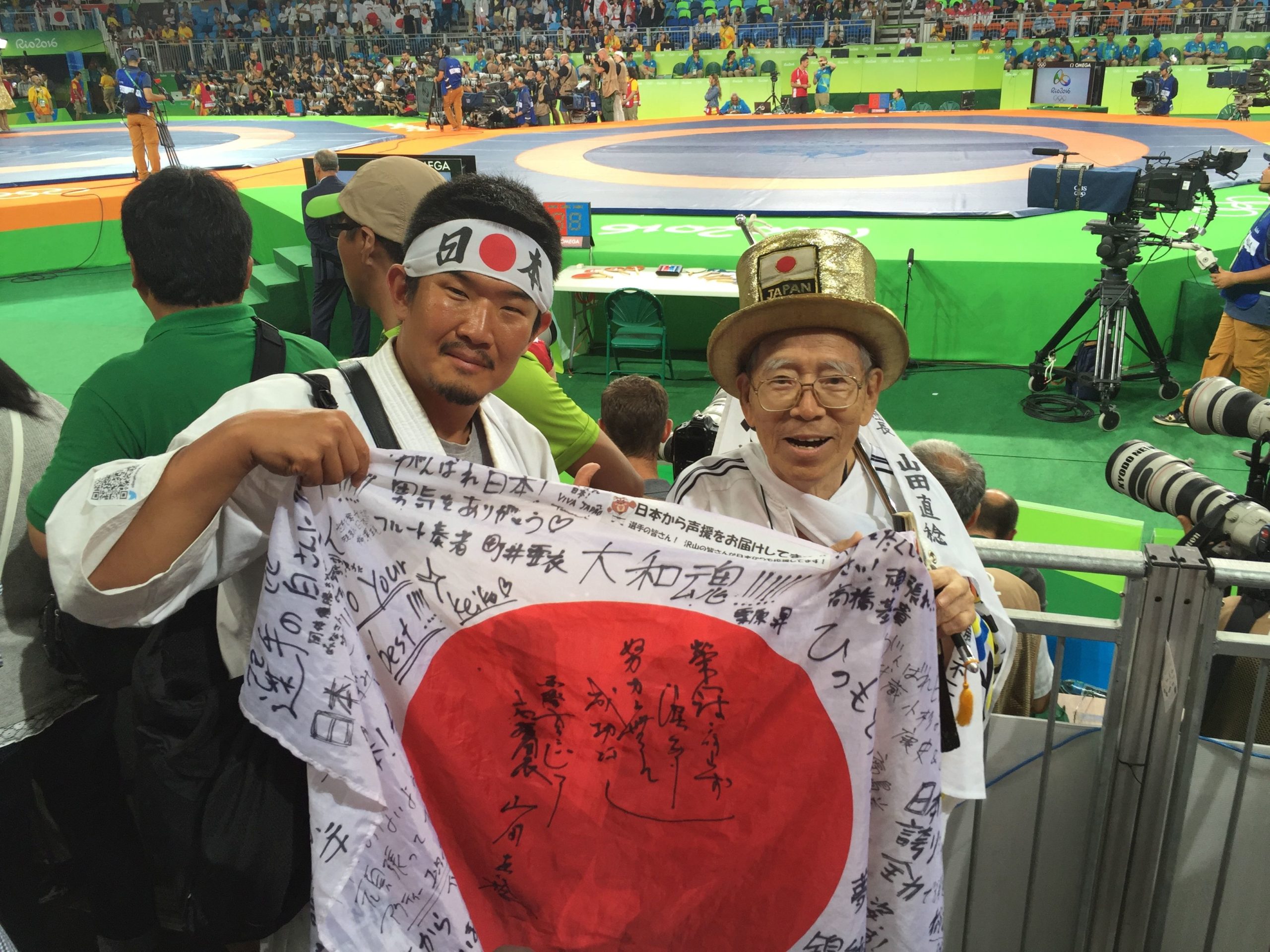 FILE PHOTO: Kazunori Takishima poses with a Japanese fan at a wrestling venue of the Rio 2016 Olympic Games in Rio de Janeiro, Brazil, August 18, 2016