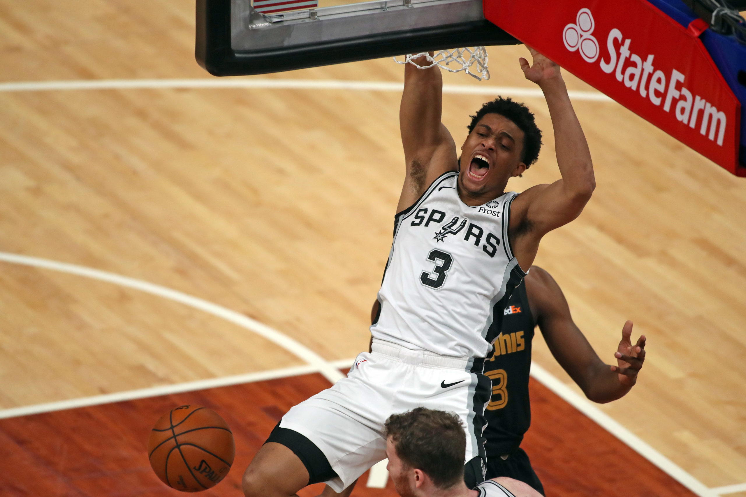 FILE PHOTO: May 19, 2021; Memphis, Tennessee, USA; San Antonio Spurs forward Keldon Johnson (3) reacts during a dunk during the second quarter against the Memphis Grizzlies at FedExForum