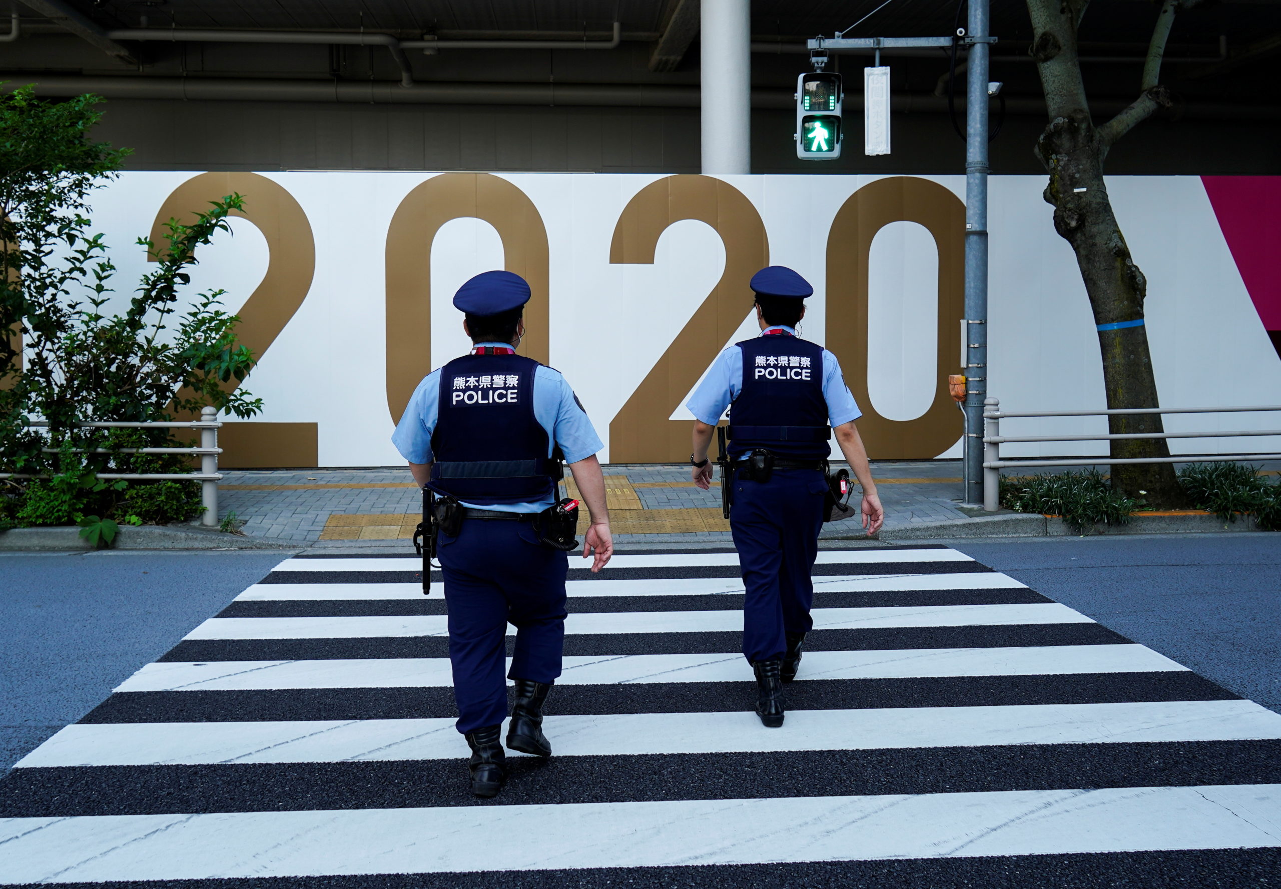 Police officers patrol outside the National Stadium, the main venue of Tokyo 2020 Olympics and Paralympics in Tokyo, Japan, July 19, 2021. 