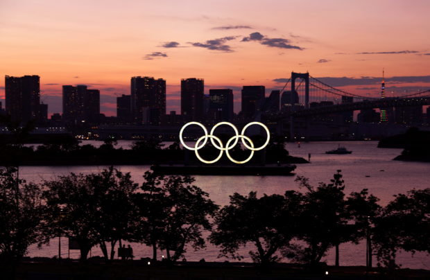 The Olympic Rings are seen in front of the skyline during sunset one night ahead of the official opening of the Tokyo 2020 Olympic Games in Tokyo, Japan, July 22, 2021. 