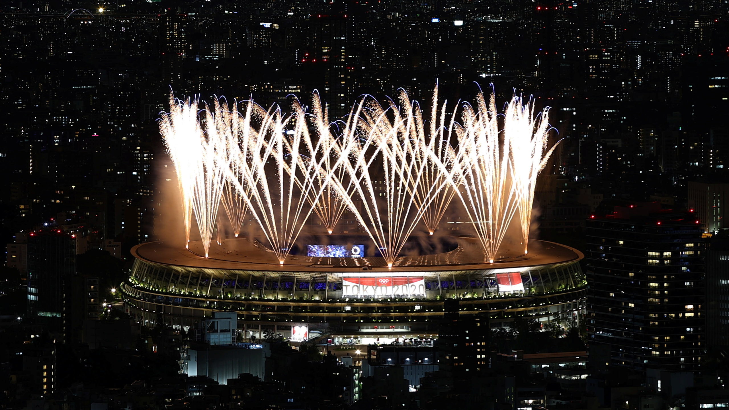 Tokyo 2020 Olympics - The Tokyo 2020 Olympics Opening Ceremony - Olympic Stadium, Tokyo, Japan - July 23, 2021. Fireworks during the opening ceremony are seen above the Olympic Stadium from the Shibuya Sky observation deck REUTERS/Kim Kyung-Hoon