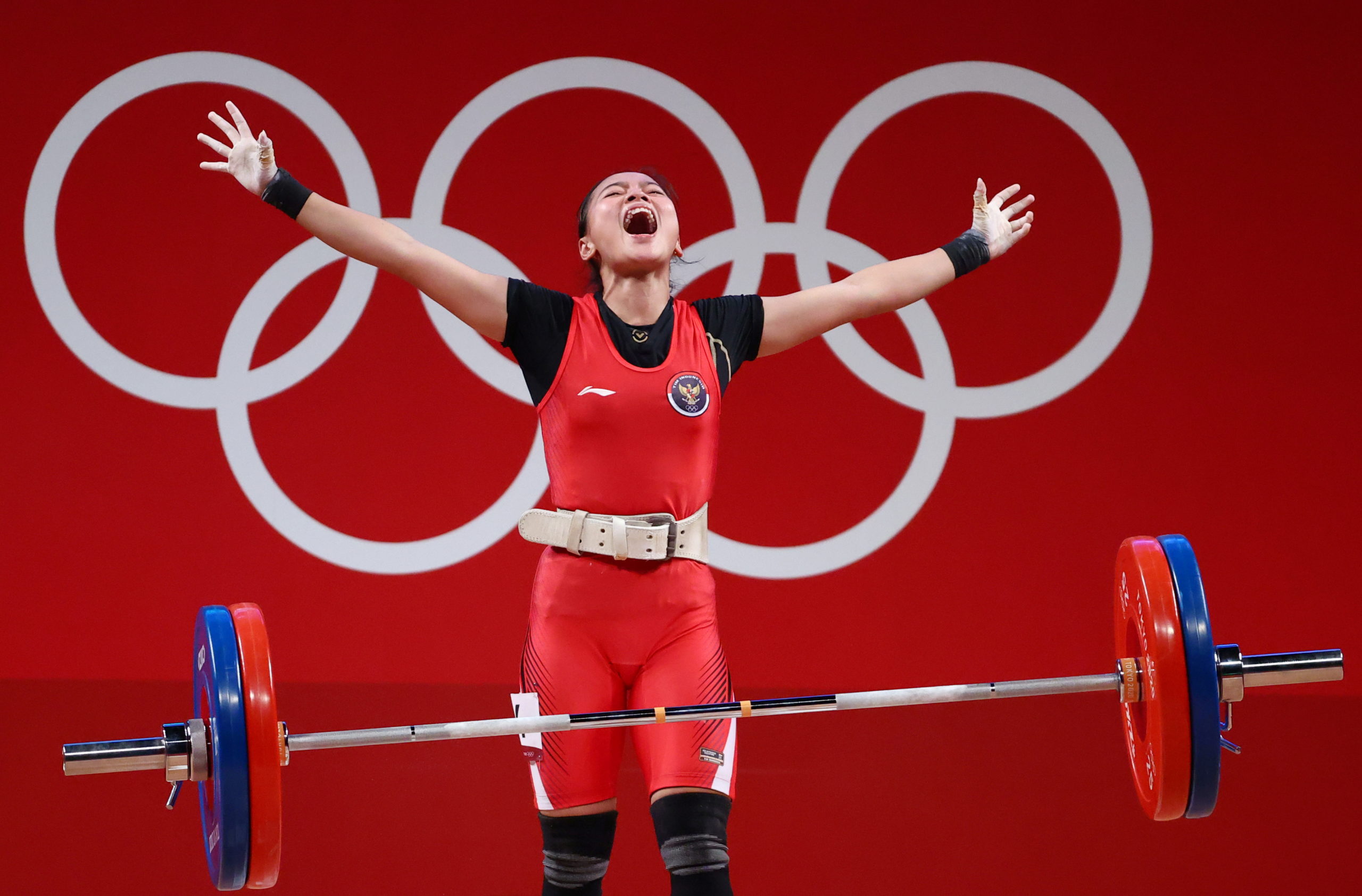 Tokyo 2020 Olympics - Weightlifting - Women's 49kg - Group A - Tokyo International Forum, Tokyo, Japan - July 24, 2021.  Windy Cantika Aisah of Indonesia reacts after a lift. 