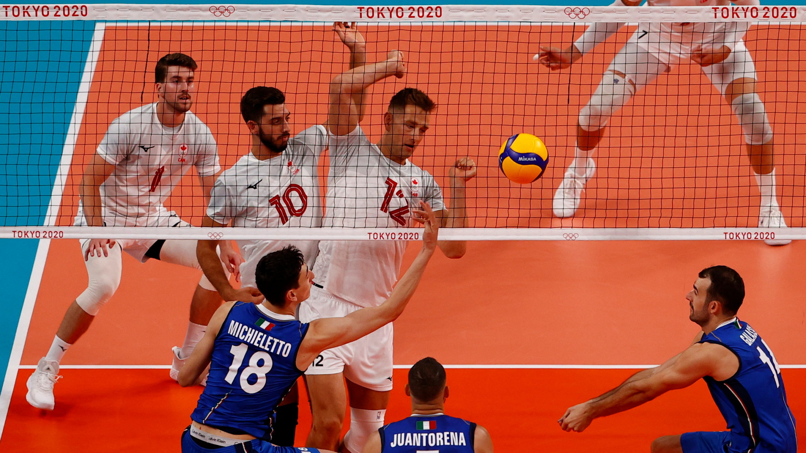 Tokyo 2020 Olympics - Volleyball - Men's Pool A - Italy v Canada - Ariake Arena, Tokyo, Japan - July 24, 2021. Lucas VanBerkel of Canada in action with Gianluca Galassi of Italy