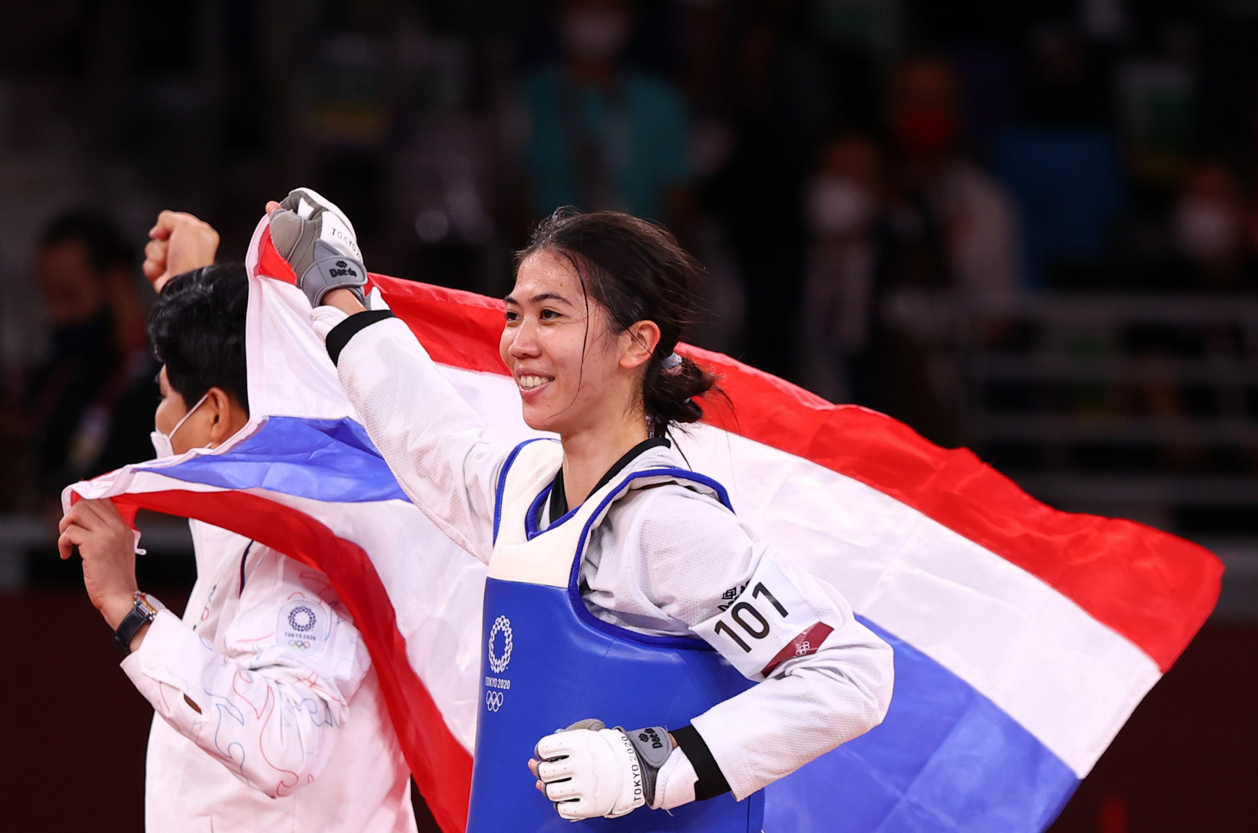 Tokyo 2020 Olympics - Taekwondo - Women's Flyweight - 49kg - Gold medal match - Makuhari Messe Hall A, Chiba, Japan - July 24, 2021. Panipak Wongphatthanakit of Thailand celebrates winning gold with the Thai national flag 