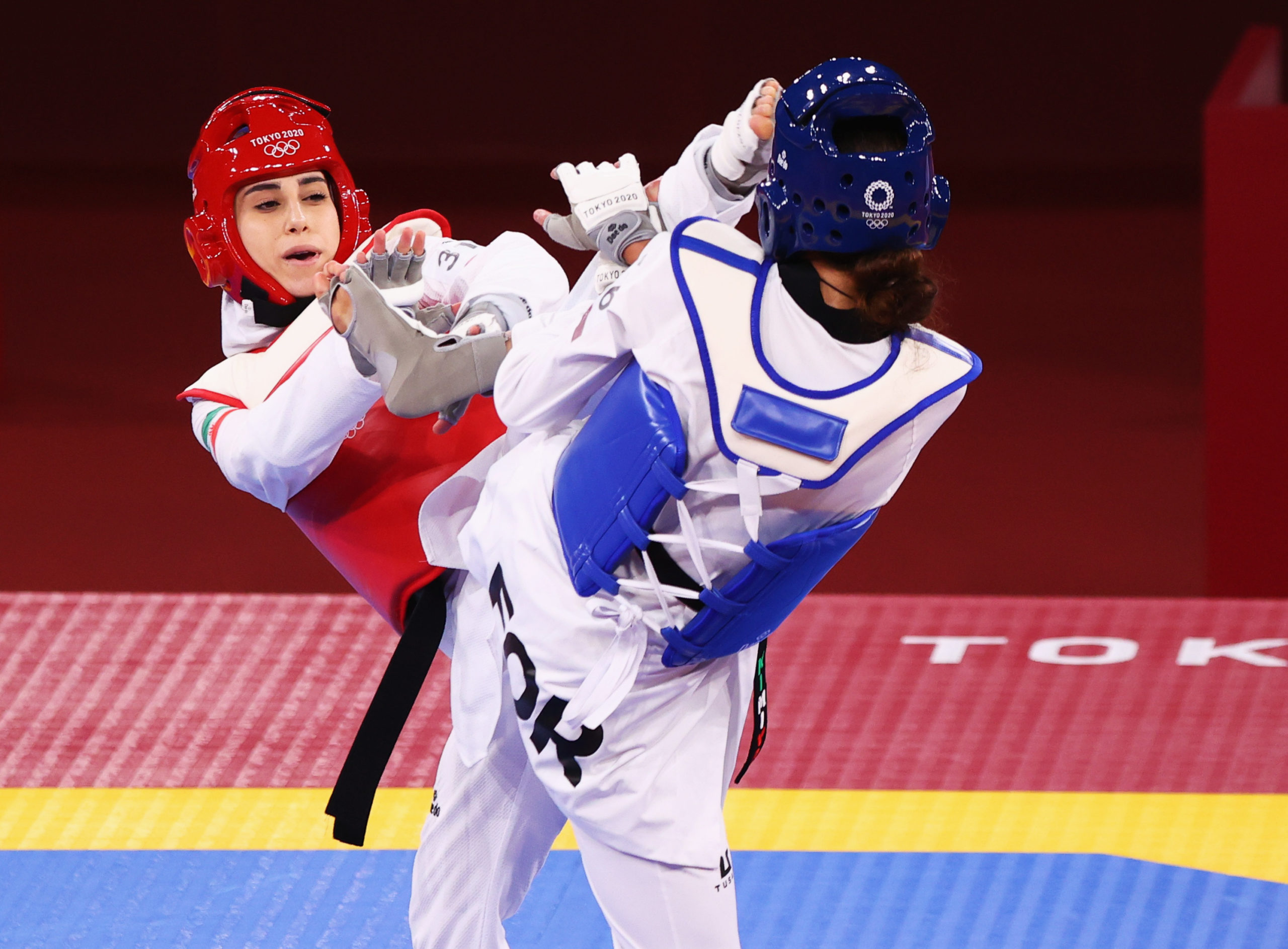 Kimia Alizadeh of the Refugee Olympic Team in action against Nahid Kiyanichandeh of Iran 