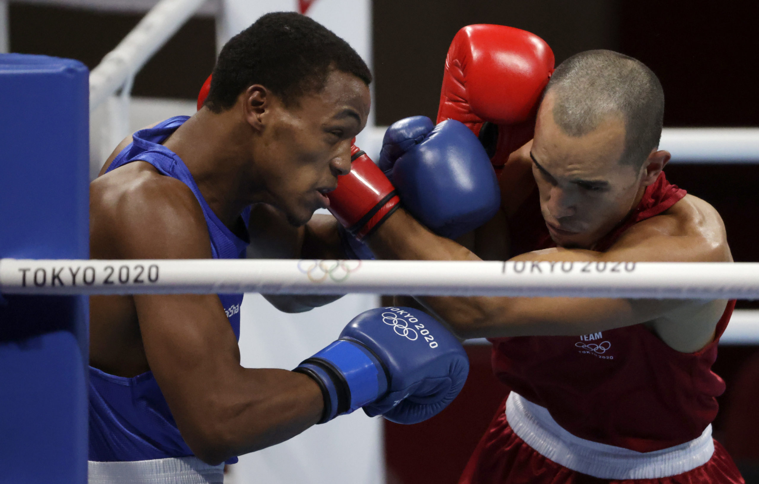 Tokyo 2020 Olympics - Boxing - Men's Middleweight - Last 32 - Kokugikan Arena - Tokyo, Japan - July 26, 2021. Eldric Sella Rodriguez of the Refugee Olympic Team in action against Euri Cedeno Martinez of the Dominican Republic 