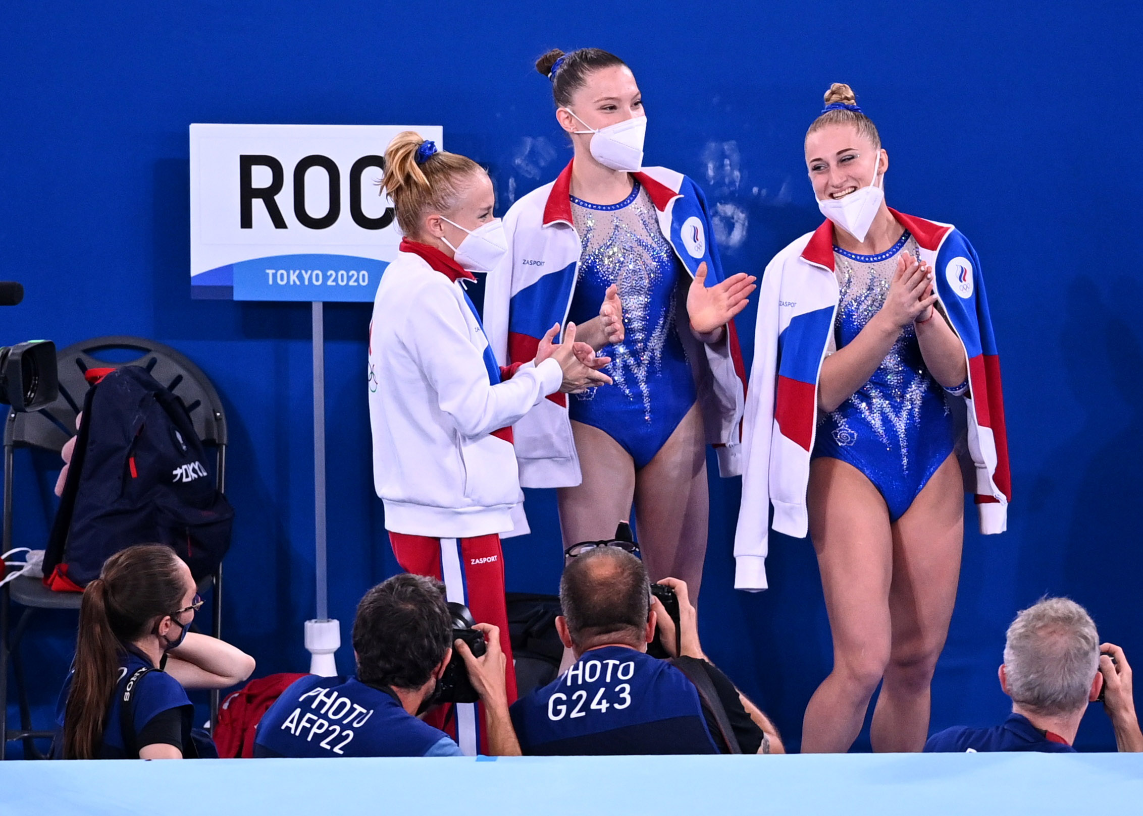 Angelina Melnikova of the Russian Olympic Committee, Vladislava Urazova of the Russian Olympic Committee and Liliia Akhaimova of the Russian Olympic Committee react wearing face protective face masks 