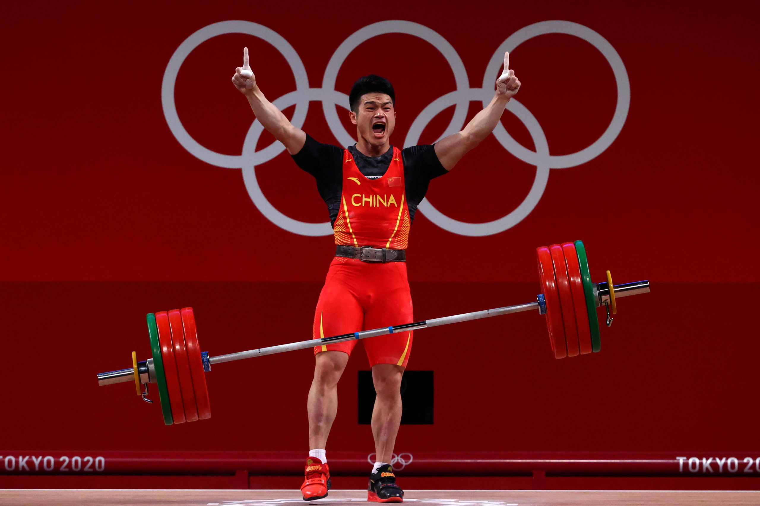 Shi Zhiyong of China celebrates after a lift.