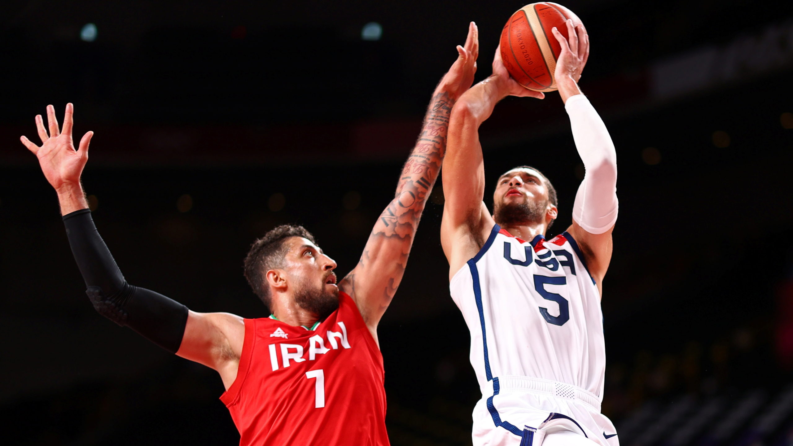 Tokyo 2020 Olympics - Basketball - Men - Group A - United States v Iran - Saitama Super Arena, Saitama, Japan - July 28, 2021. Zach Lavine of the United States in action with Mohammad Hassanzadeh of Iran 