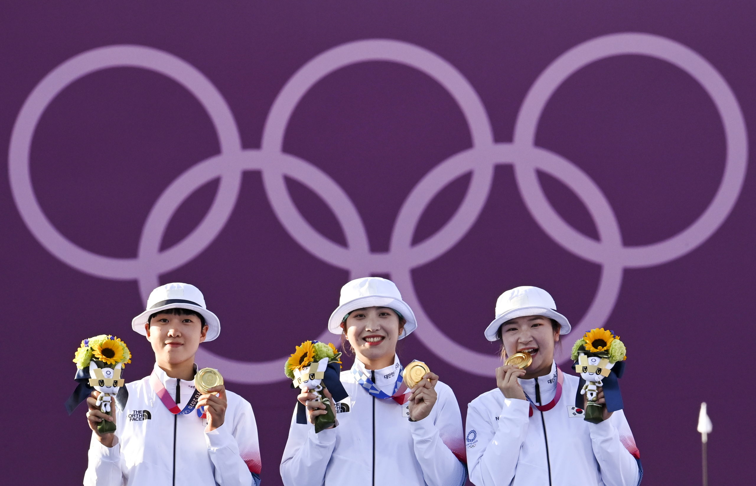 Gold medalist An San of South Korea, gold medallist Jang Minhee of South Korea and gold medallist Kang Chae Young of South Korea celebrate on the podium. 