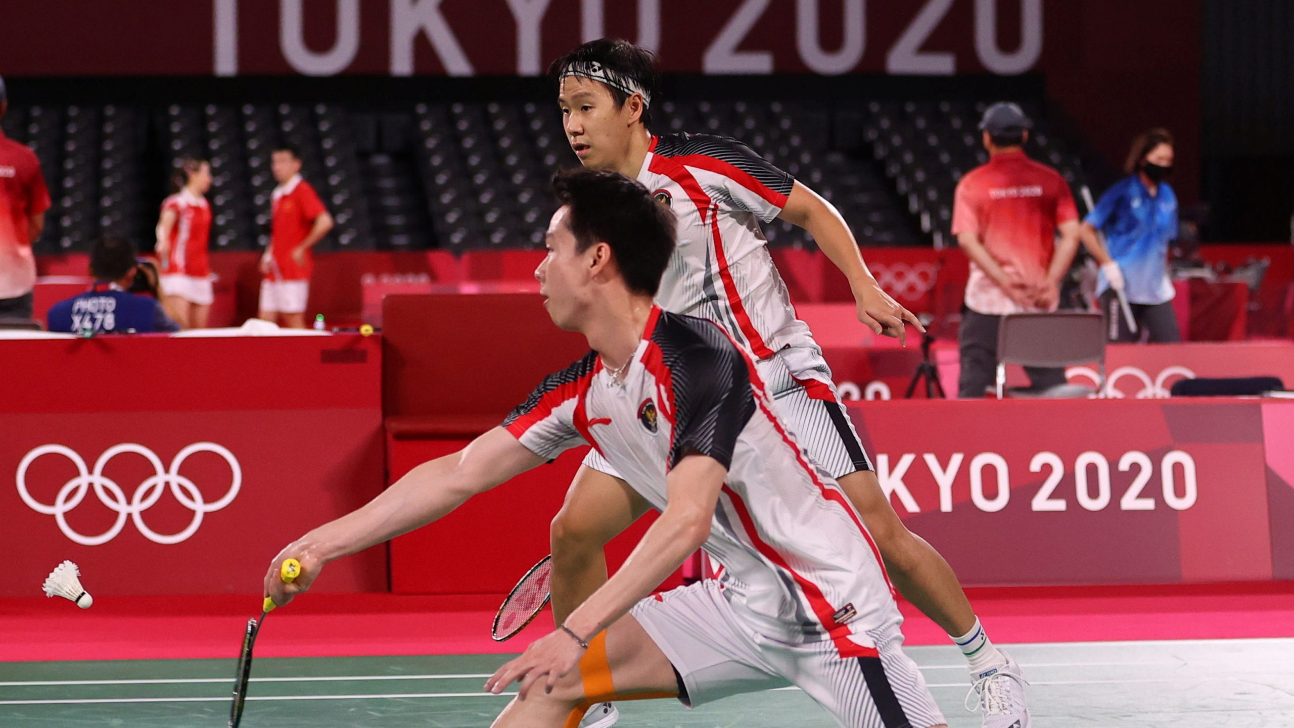 Kevin Sanjaya Sukamuljo of Indonesia in action as Marcus Fernaldi Gideon of Indonesia looks on during the match against Aaron Chia of Malaysia and Soh Wooi Yik of Malaysia.