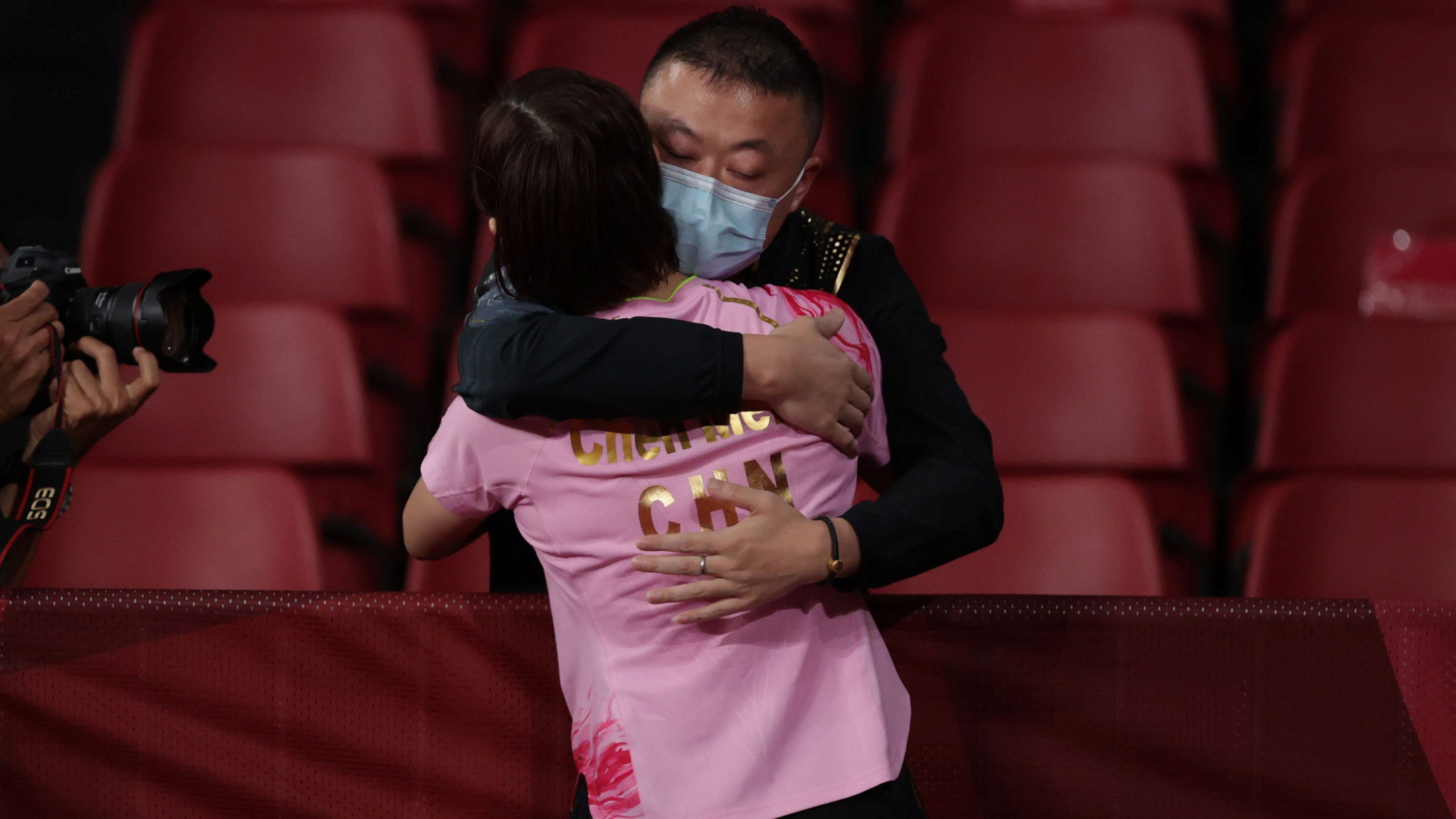 Chen Meng of China celebrates with coach Ma Lin after winning her match against Sun Yingsha of China