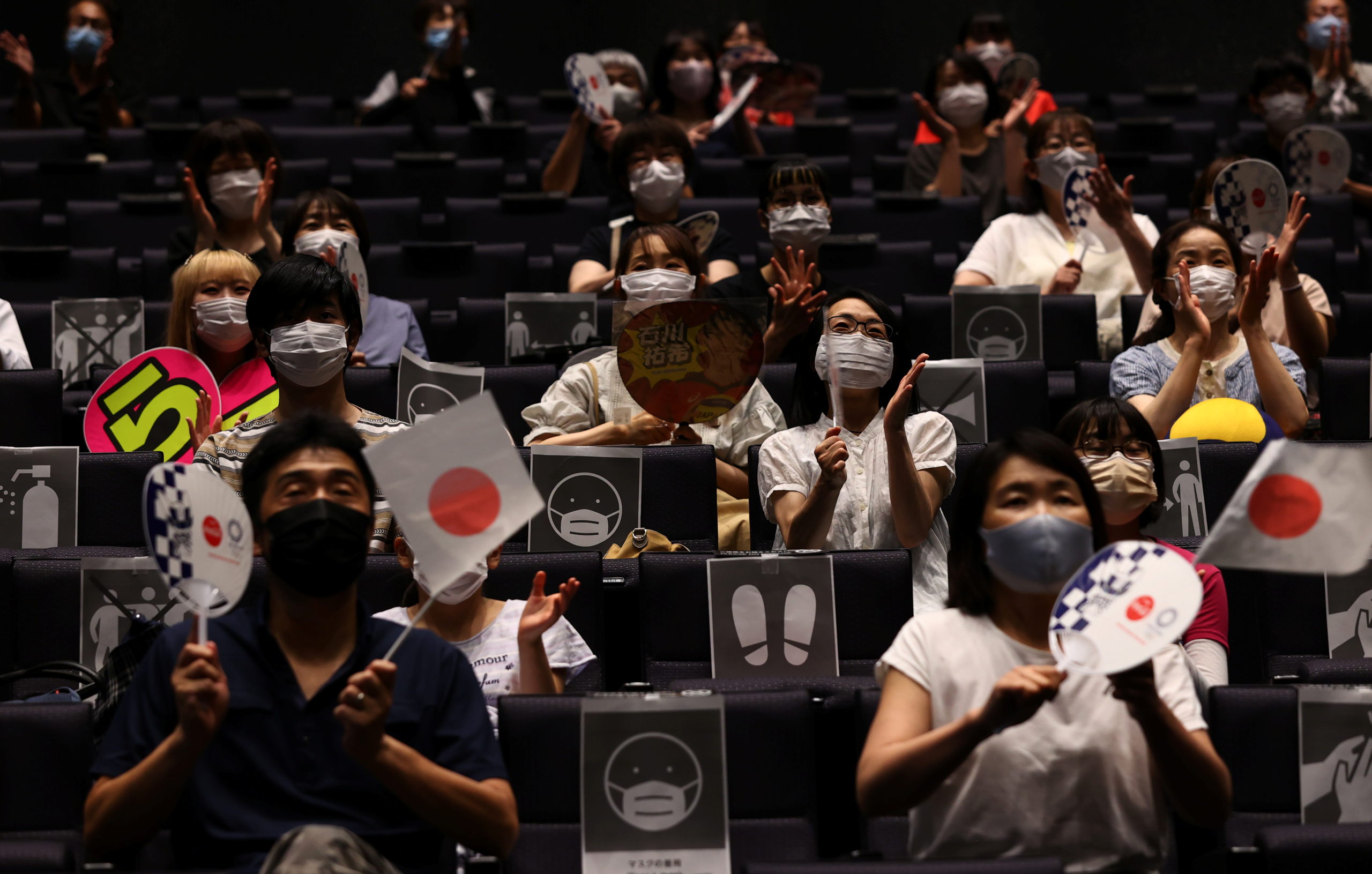 People watch live broadcasting of volleyball match between Japan and Poland on a large screen during a public viewing event for Tokyo 2020 Olympic Games at a theatre in Takasaki, Gunma Prefecture, Japan, July 30, 2021