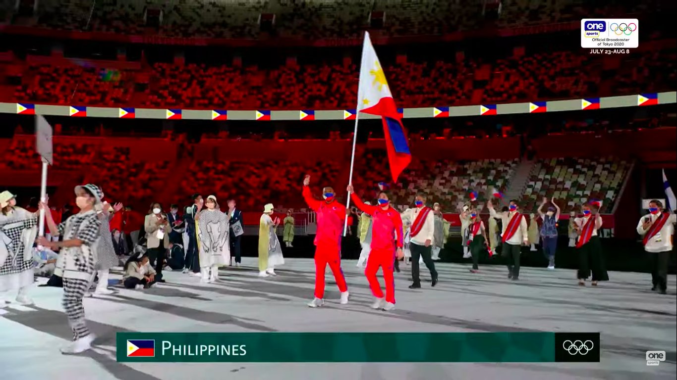 Eumir Marcial and Kiyomi Watanabe carrying Philippine flag at the Tokyo Olympics opening ceremony.