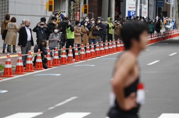 Small number of spectators are seen near the finish point at the half-marathon of Hokkaido-Sapporo Marathon Festival 2021, a test event for the Tokyo 2020 Olympics marathon race, in Sapporo on May 5, 2021. (Photo by ISSEI KATO / POOL / AFP)