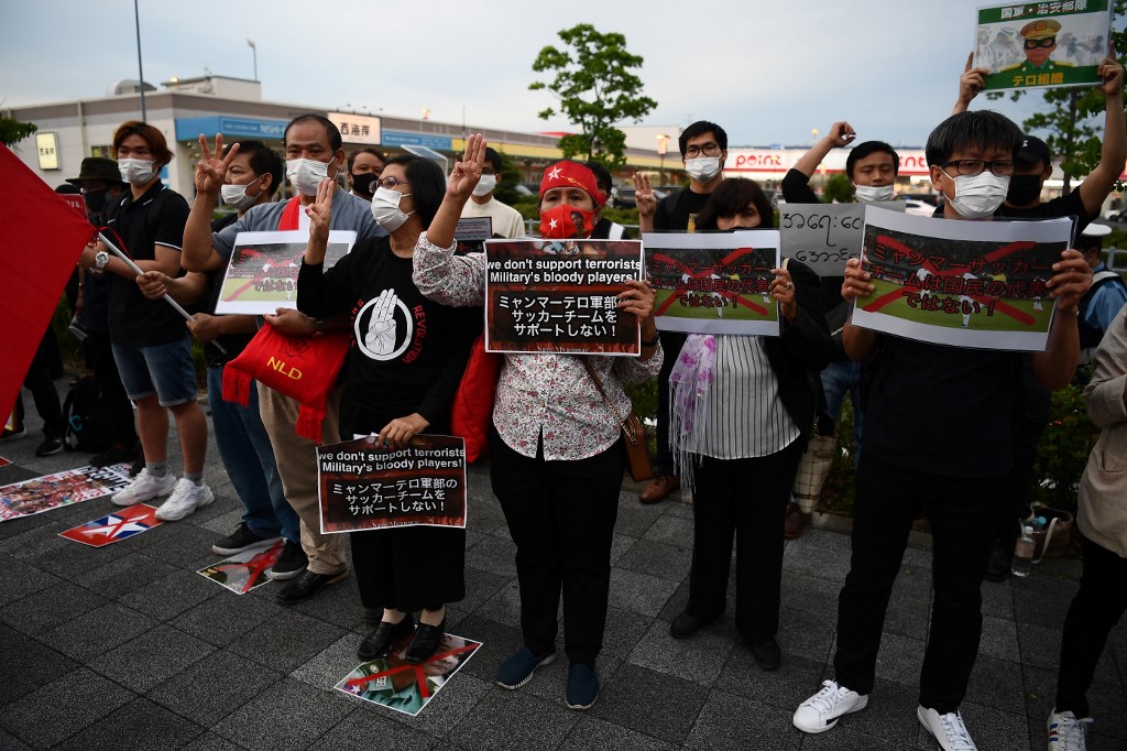 Demonstrators protest against the military coup in Myanmar outside Fukuda Denshi Arena stadium in Chiba on May 28, 2021, ahead of the FIFA World Cup Qatar 2022 Asian zone group F qualification football match between Japan and Myanmar.