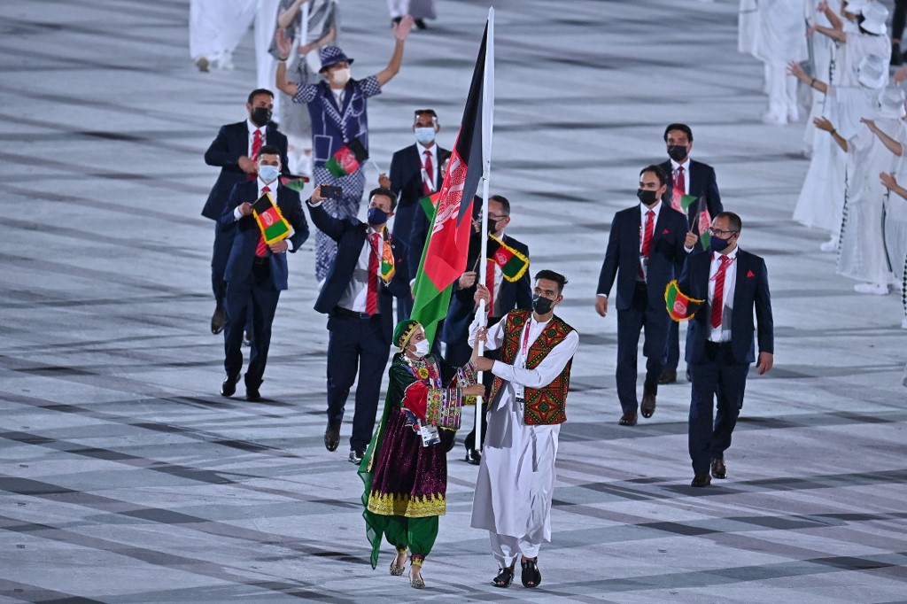 Afghanistan's flag bearer Kimia Yousofi and Afghanistan's flag bearer Farzad Mansouri lead the delegation during the opening ceremony of the Tokyo 2020 Olympic Games
