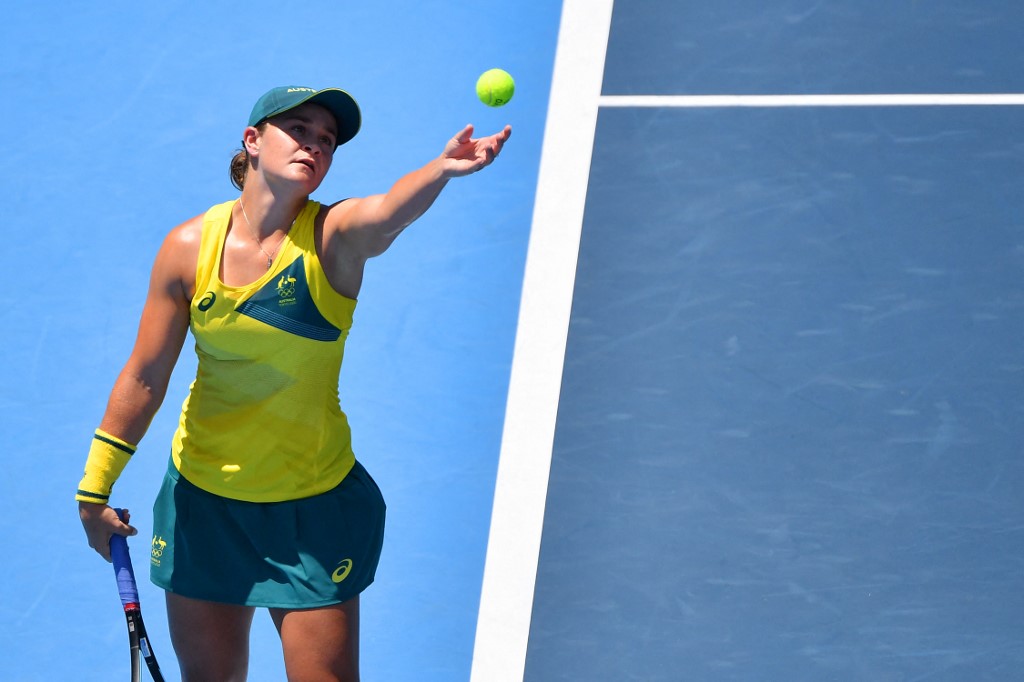 Australia's Ashleigh Barty serves to Spain's Sara Sorribes Tormo during their Tokyo 2020 Olympic Games women's singles first round tennis match at the Ariake Tennis Park in Tokyo on July 25, 2021. (