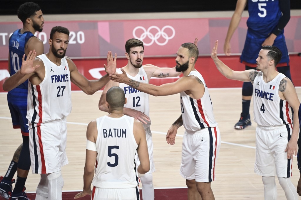 France's Rudy Gobert (L) celebrates a play with teammates during the men's preliminary round group A basketball match between France and USA during the Tokyo 2020 Olympic Games at the Saitama Super Arena in Saitama on July 25, 2021. 