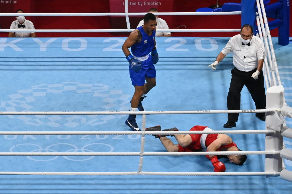 Armenia's Arman Darchinyan falls KO as he fights Philippines' Eumir Marcial during their men's middle (69-75kg) quarter-final boxing match during the Tokyo 2020 Olympic Games at the Kokugikan Arena in Tokyo on August 1, 2021. 