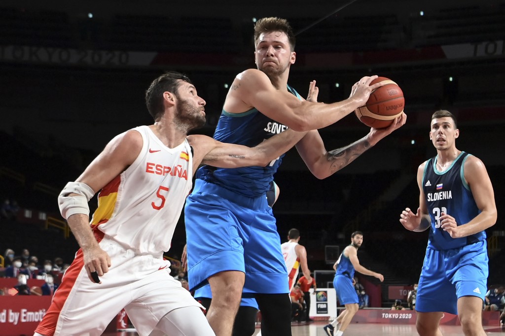 Slovenia's Luka Doncic defends the ball from Spain's Rodolfo Fernandez (L) in the men's preliminary round group C basketball match between Spain and Slovenia during the Tokyo 2020 Olympic Games at the Saitama Super Arena in Saitama 