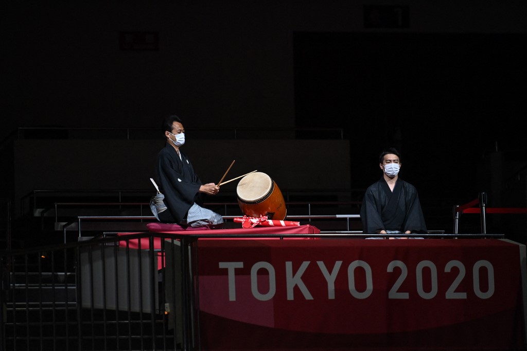 Musicians perform traditional music at the start of a boxing match during the Tokyo 2020 Olympic Games at the Kokugikan Arena in Tokyo on August 3, 2021.