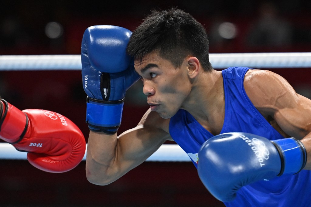 Uzbekistan's Shakhobidin Zoirov (red) and Philippines' Carlo Paalam fight during their men's fly (48-52kg) quarter-final boxing match during the Tokyo 2020 Olympic Games at the Kokugikan Arena in Tokyo on August 3, 2021. 