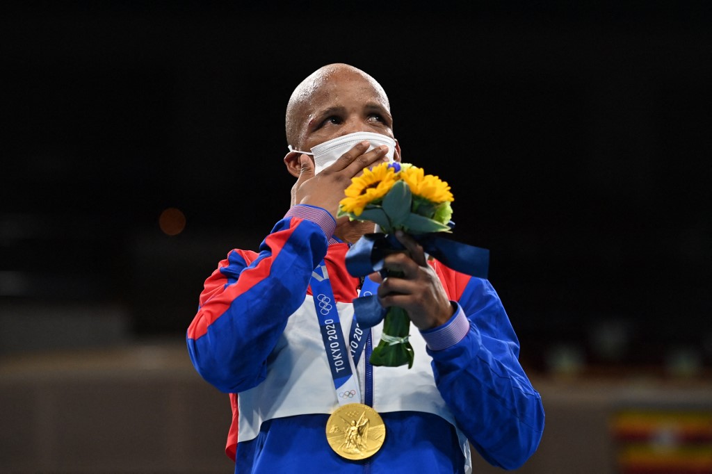 Gold medalist Cuba's Roniel Iglesias celebrates on the podium after the men's welter (63-69kg) boxing final bout during the Tokyo 2020 Olympic Games at the Kokugikan Arena in Tokyo on August 3, 2021. 