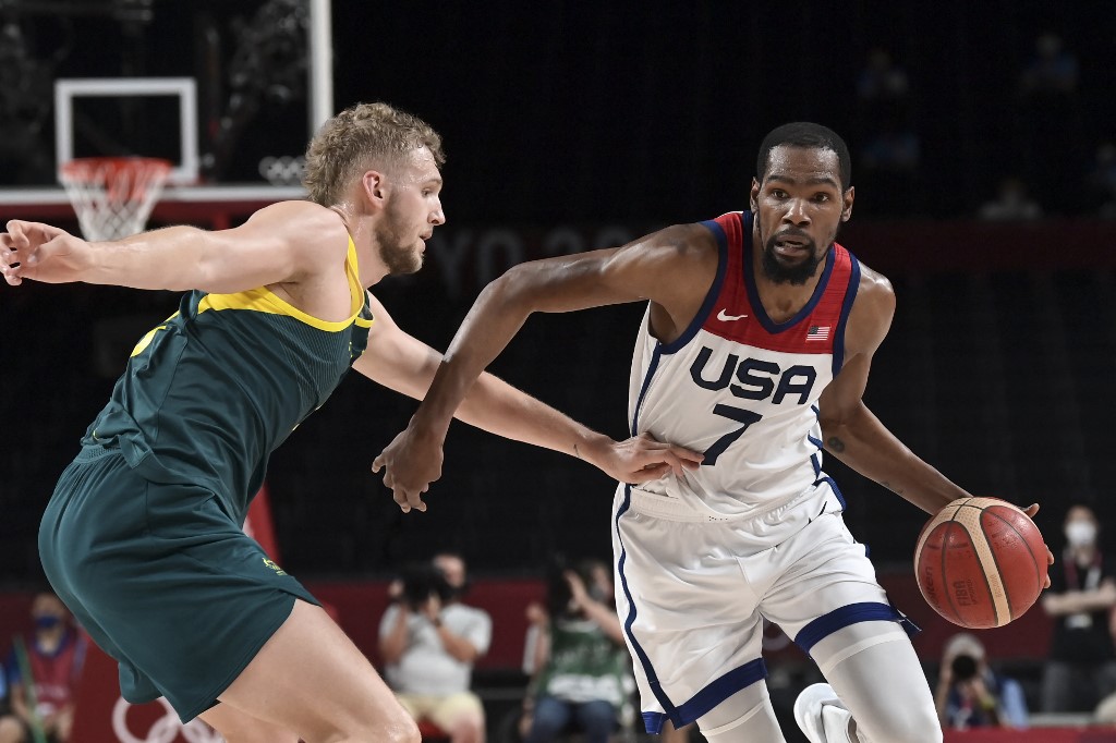 USA's Kevin Wayne Durant dribbles the ball past Australia's Jock Landale (L) in the men's semi-final basketball match between Australia and USA during the Tokyo 2020 Olympic Games at the Saitama Super Arena in Saitama on August 5, 2021. 