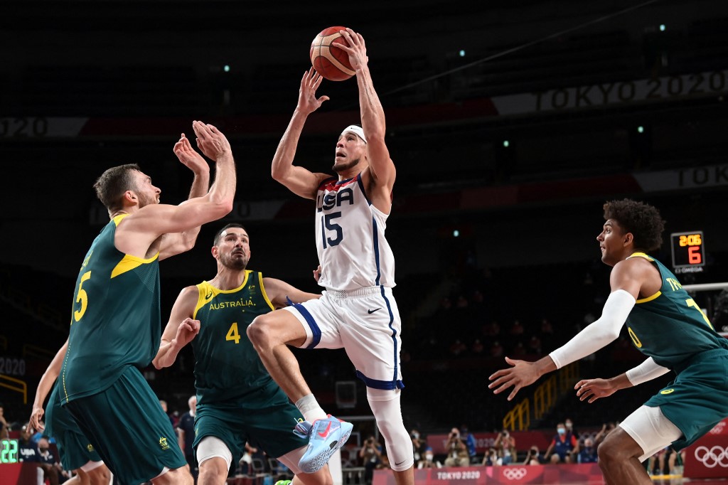 USA's Devin Booker goes to the basket  past Australia's Nic Kay (L) in the men's semi-final basketball match between Australia and USA during the Tokyo 2020 Olympic Games at the Saitama Super Arena in Saitama on August 5, 2021. 