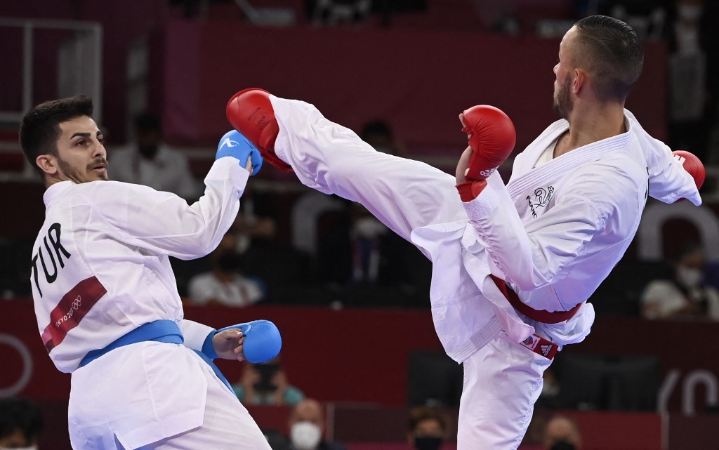 France's Steven Da Costa (R) competes against Turkey's Eray Samdan in the men's kumite -67kg final in the karate competition during the Tokyo 2020 Olympic Games at the Nippon Budokan in Tokyo on August 5, 2021