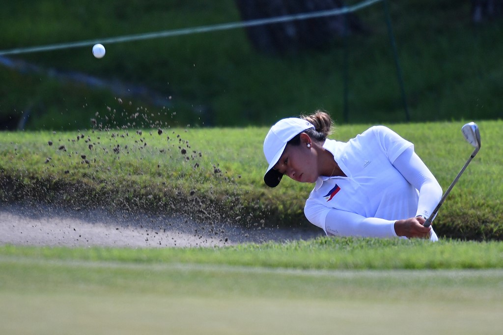 Philippines' Bianca Pagdanganan plays a shot out of the bunker on the 9th hole in round 3 of the women’s golf individual stroke play during the Tokyo 2020 Olympic Games at the Kasumigaseki Country Club in Kawagoe on August 6, 2021.