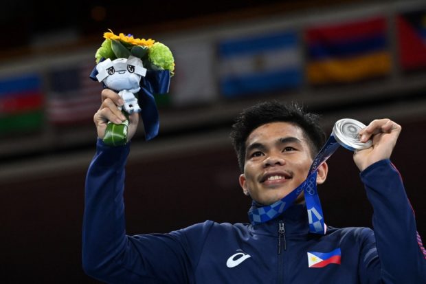 Philippines' Carlo Paalam celebrates his silver medal during the medal ceremony for the men's fly (48-52kg) boxing final bout during the Tokyo 2020 Olympic Games