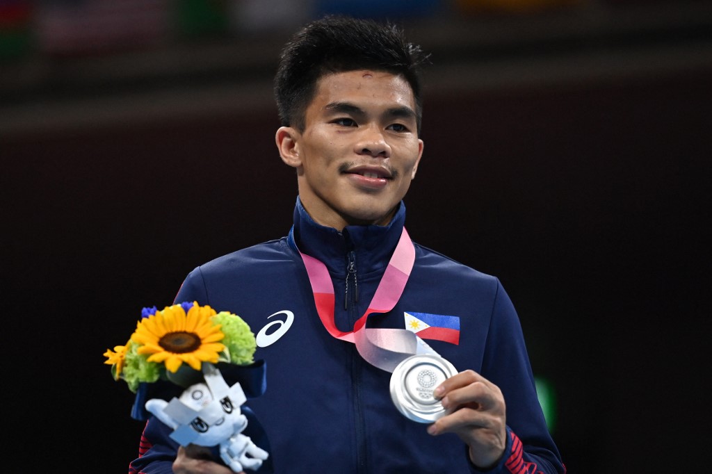 Philippines' Carlo Paalam celebrates his silver medal during the medal ceremony for the men's fly (48-52kg) boxing final bout during the Tokyo 2020 Olympic Games at the Kokugikan Arena in Tokyo on August 7, 2021.