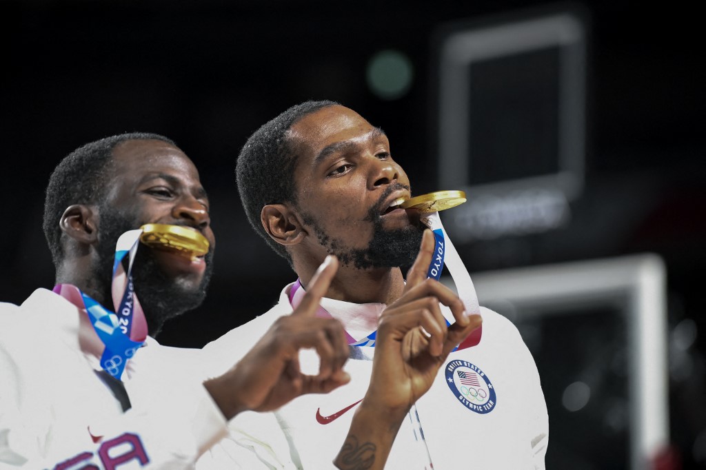 USA's Kevin Wayne Durant (R) and Draymond Jamal Green celebrate with their gold medals in podium during the medal ceremony for the men's basketball competition of the Tokyo 2020 Olympic Games at the Saitama Super Arena in Saitama on August 7, 2021.