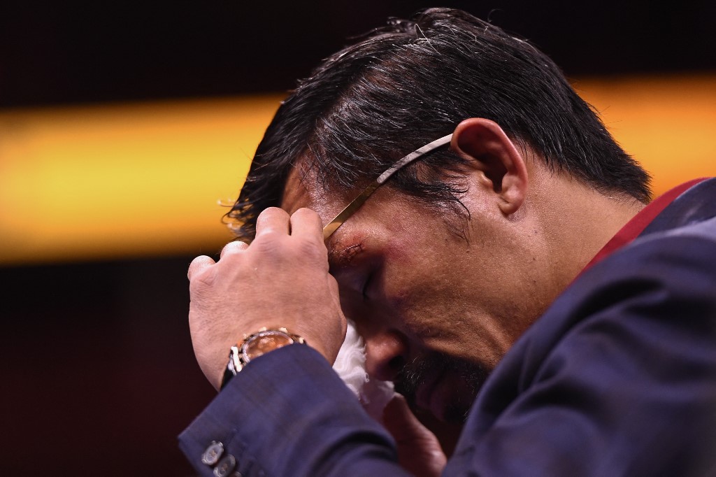 Manny Pacquiao of the Philippines wipes his face during a press conference after his defeat to Yordenis Ugas of Cuba in the WBA Welterweight Championship boxing match at T-Mobile Arena in Las Vegas on August 21, 2021.