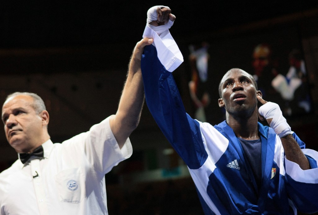 Cuba's Yordenis Ugas is declared winner after defeating Italy's Domenico Valentino during their 2008 Olympic Games Lightweight (60 kg) boxing bout on August 15, 2008 in Beijing.