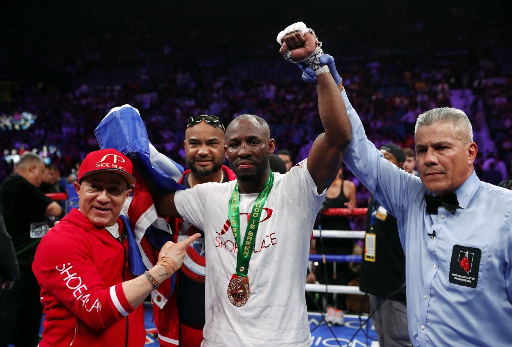 Yordenis Ugas (C) poses with referee Russell Mora and members of his team after defeating Omar Figueroa Jr. during a welterweight bout at MGM Grand Garden Arena on July 20, 2019 in Las Vegas, Nevada. Ugas won the fight by unanimous decision. 