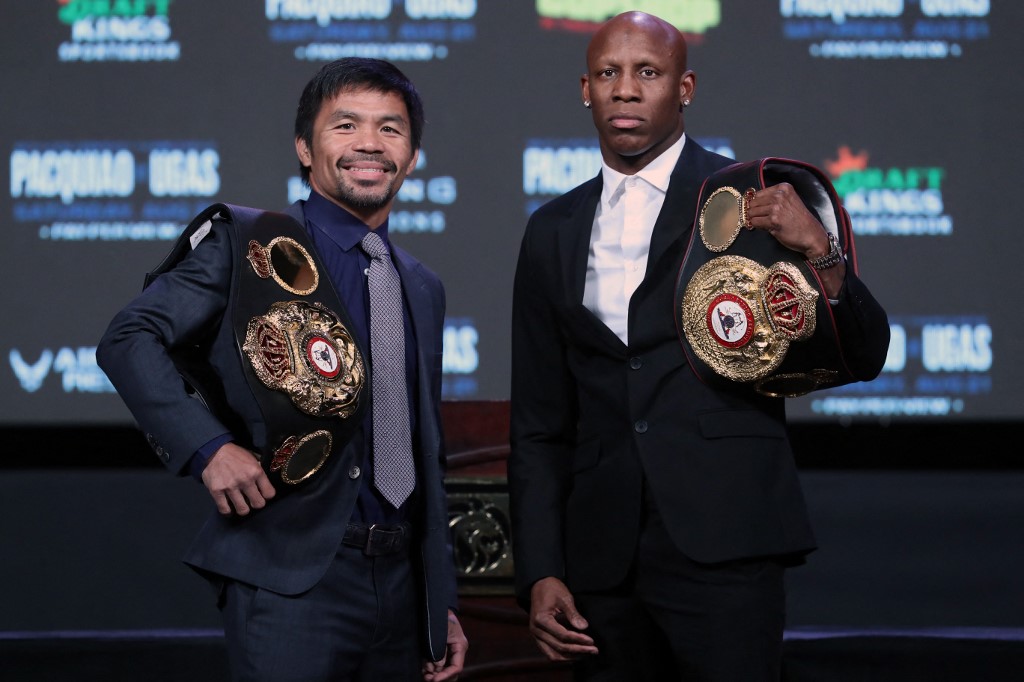  Manny Pacquiao (L) and WBA welterweight champion Yordenis Ugas pose during a news conference at MGM Grand Garden Arena on August 18, 2021 in Las Vegas, Nevada. Pacquiao will challenge Ugas for his title at T-Mobile Arena on August 21 in Las Vegas.  